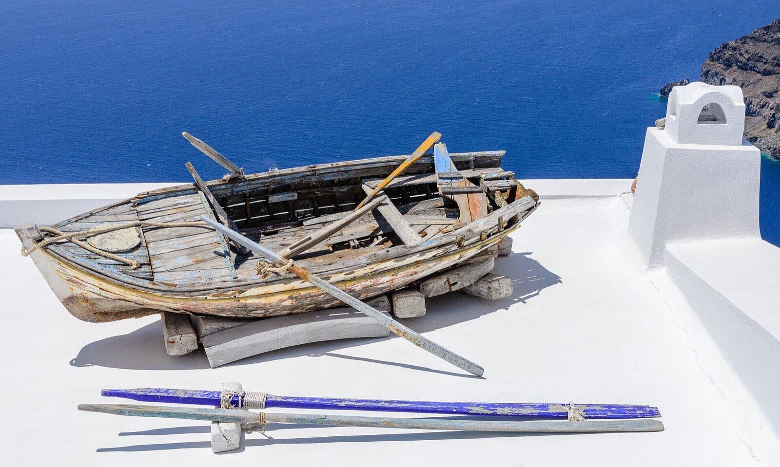 Rowing boat on a house roof, Fira, Santorini, Greece.