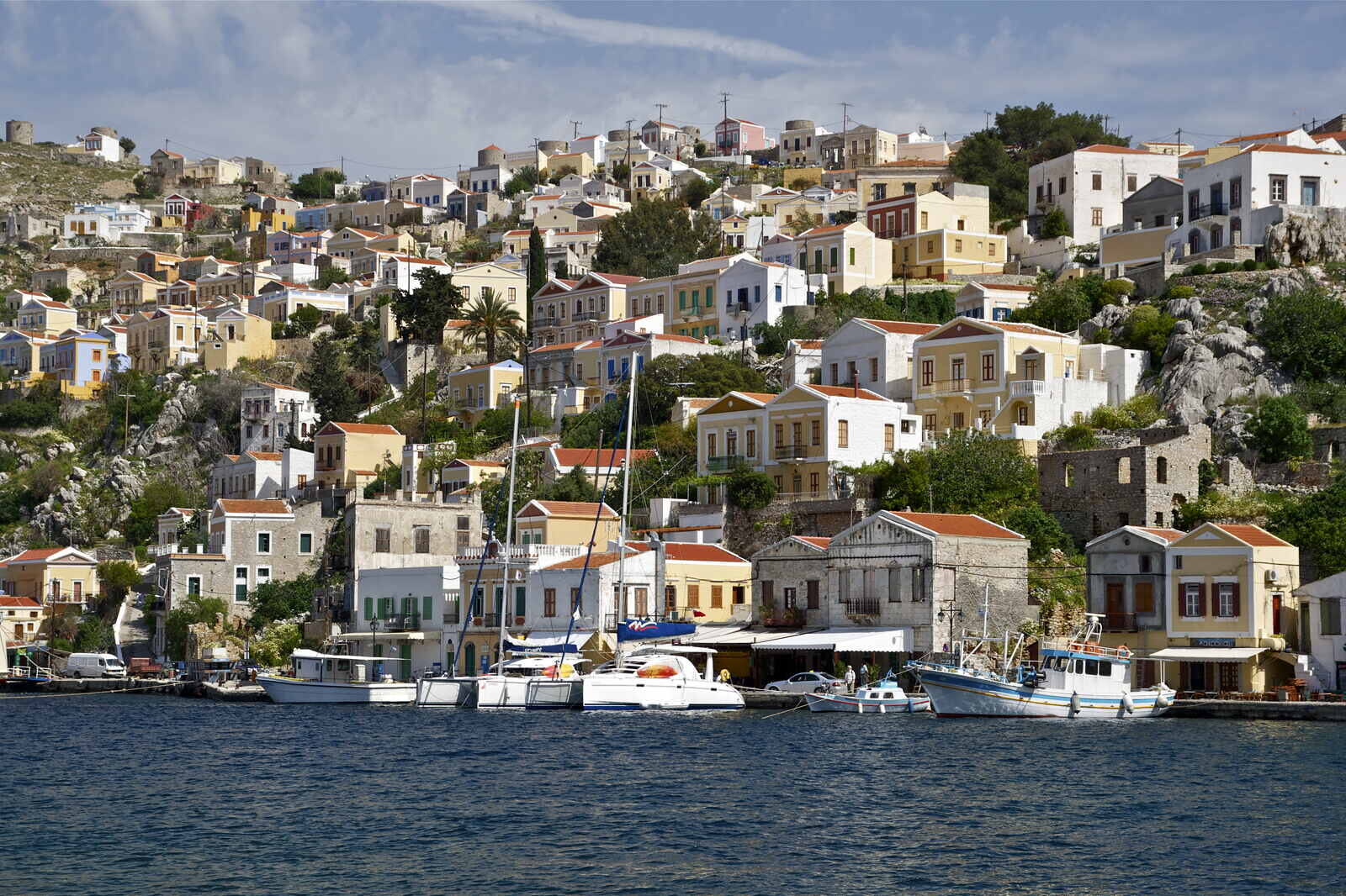 Fargerike hus i havnebyen Symi i Dodekanesene under klar vårhimmel